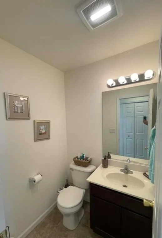 This is an image from Shabby Brown Restore, located in New York. The bathroom features clean white walls, a single-sink vanity, and a simple, compact layout.