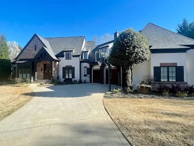 Exterior painting project by Avanti Painting LLC in Mooresville, NC. The image shows a large home with light siding, dark shutters, and a driveway.