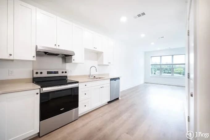 J. Ross Painting & Drywall painting project in Kingsport, Tennessee. The image shows a white breakroom with black appliances.