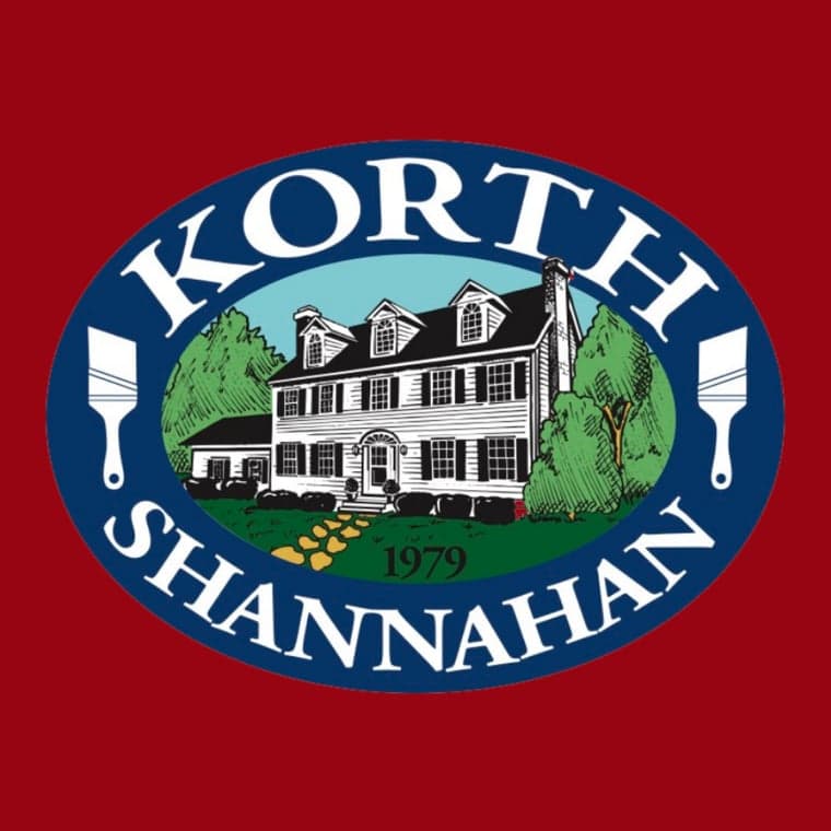This is an image from Korth & Shannahan Painting and Carpentry, located in New York. The logo for Korth & Shannahan Painting and Carpentry features an illustrated colonial-style home with two paintbrushes and the business name in a blue oval.