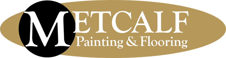 This is an image from Metcalf Painting & Flooring, located in North Carolina. The logo for Metcalf Painting & Flooring features a bold white 'M' on a black circle set against a gold oval background with elegant serif lettering in white.