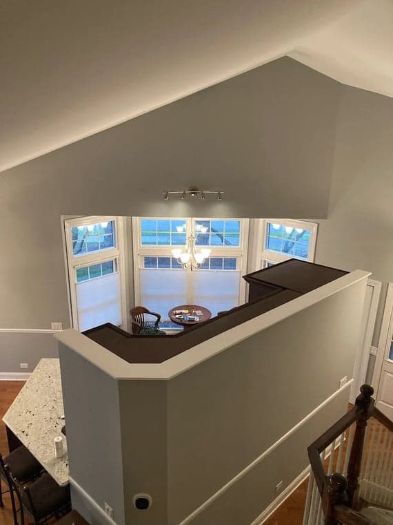 Interior painting by Affordable Interior & Exterior Painting in Glen Ellyn, Illinois. The image shows gray walls around a staircase and vaulted landing.