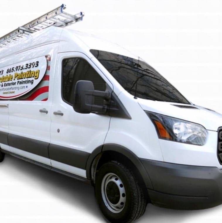 This is an image from Jakes Affordable Painting, located in Tennessee. The logo for Jakes Affordable Painting features bold lettering on a white service van with red accent stripes and exterior painting branding.