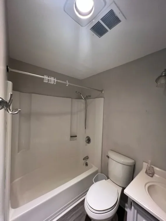Interior painting project by CertaPro Painters of Wilmington NC in Wilmington, North Carolina. The image shows a small bathroom with gray walls and a white tub.