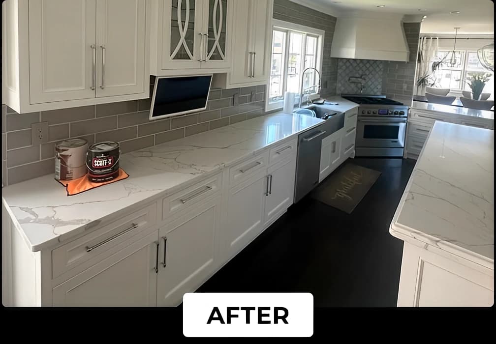 A kitchen updated by Lucena Painting with white cabinets, marble countertops, gray subway tile backsplash, and fresh coats of paint for a polished look.