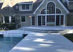 This is an image from Paul’s Painting & Powerwashing, located in New Jersey. The image shows a clean poolside deck and exterior area following professional power washing services.