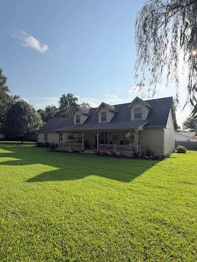 Painting work by Scott Brown Professional Painting & Remodeling in Chattanooga, Tennessee. The image shows a light house exterior facing a green lawn.