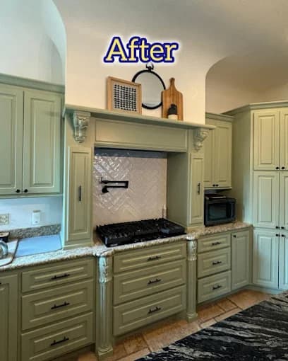 This is an image from Reed’s Home Improvement, located in Louisiana. The photo shows a remodeled kitchen with freshly painted sage green cabinets, granite countertops, and a white tile backsplash surrounding a modern stovetop area.