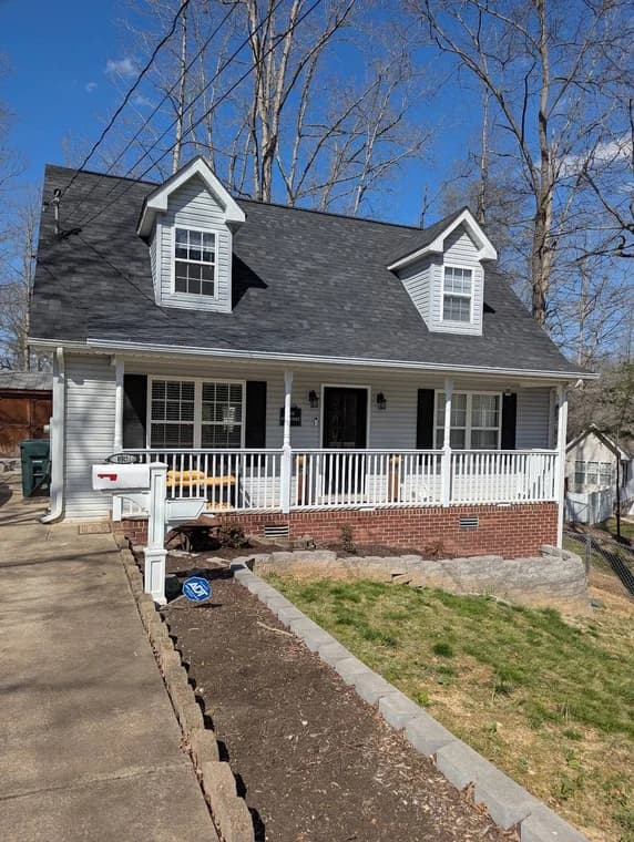 Small home with a gray exterior and white trim painted by CertaPro Painters of Clarksville, Tennessee and Hopkinsville, Kentucky.
