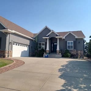 Exterior painting by All Painting Plus 2, LLC in Colorado Springs, Colorado. The image shows gray walls around an entry.