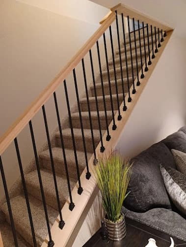Interior painting by All Painting Plus 2, LLC in Colorado Springs, Colorado. The image shows light walls and dark stair railings.