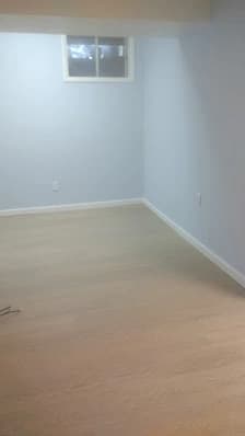 Interior painting by Brush Brothers Painting LLP in Golden, Colorado. The image shows pale blue walls in an empty room.