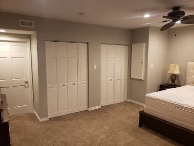 Interior painting by Brush Brothers Painting LLP in Golden, Colorado. The image shows pale bedroom walls and white closet doors.