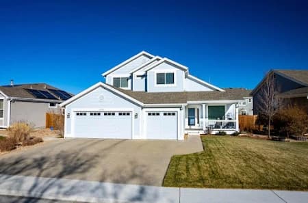 Exterior painting by Imperial Painters in Denver, Colorado. The image shows white siding around garages.