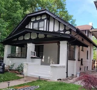 Exterior painting by Imperial Painters in Denver, Colorado. The image shows white walls and dark decorative trim.