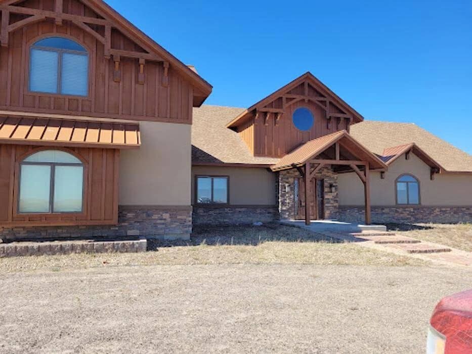 Pro Classic Painting in Aurora, CO: painting. The image shows red-brown exterior siding.