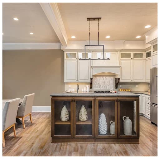 Interior painting by CertaPro Painters of Columbus OH in Columbus, OH. The image shows white kitchen with central island and hanging lights.