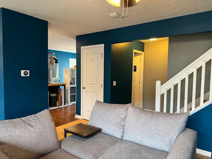 Interior painting by CertaPro Painters of Columbus OH in Columbus, OH. The image shows navy accent wall beside a white staircase.