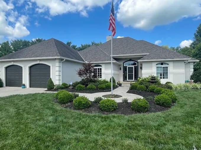 Exterior painting by CertaPro Painters of Columbus OH in Columbus, OH. The image shows light gray ranch house with arched garage bays.