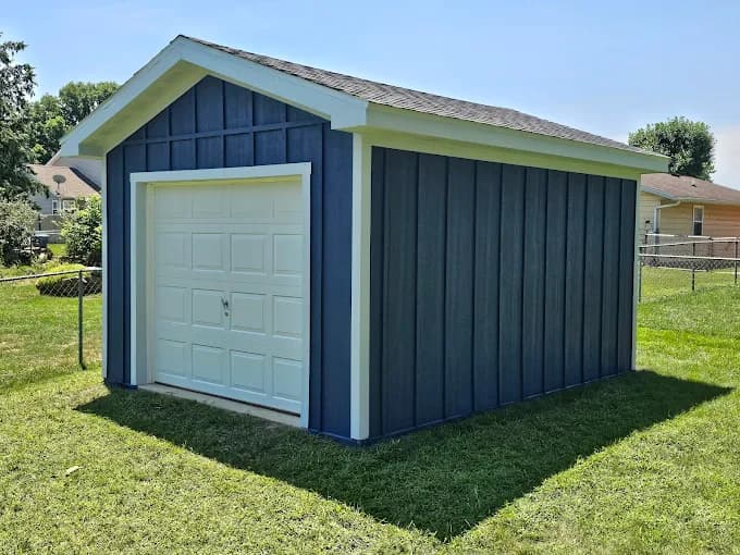 Elsner Painting & Pressure Washing Inc in Sidney, OH: painting. The image shows blue shed siding and white door trim.