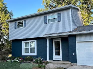 Elsner Painting & Pressure Washing Inc in Sidney, OH: painting. The image shows blue lower siding and white upper siding.