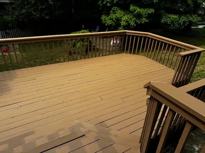 Deck staining by 360 Painting of Columbus in Reynoldsburg, Ohio. The image shows wood decking enclosed by dark rails.