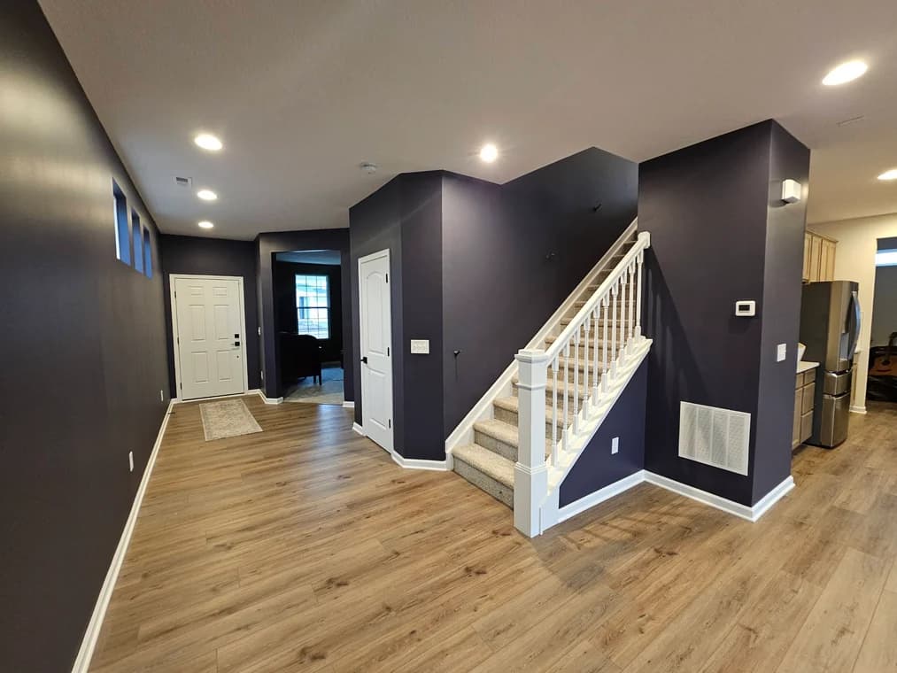 Interior painting by Promus Home Improvement Co in Grove City, Ohio. The image shows dark walls around a staircase.