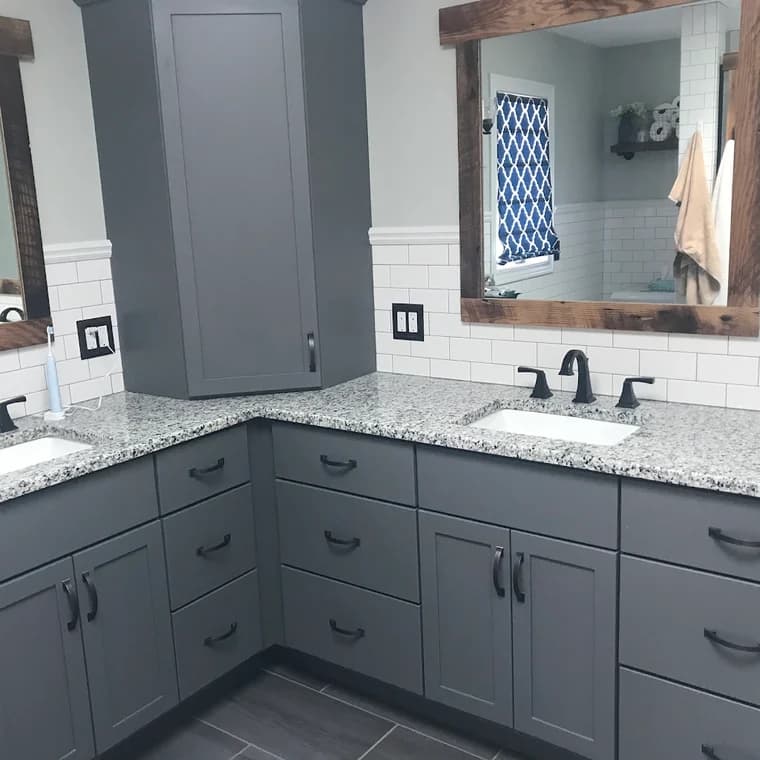 Cabinet painting by Skye Painting Llc in Ohio. The image shows gray vanity cabinets below a white counter.