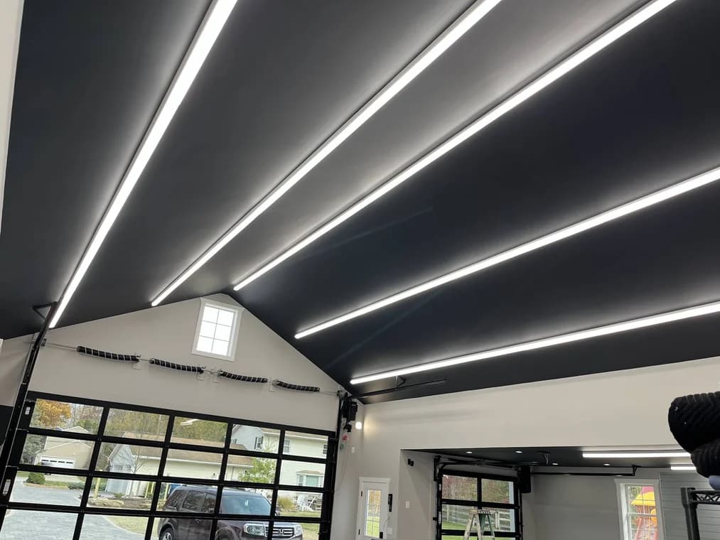 Interior painting by Skye Painting Llc in Ohio. The image shows dark ceiling panels with long light strips.