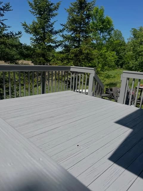 Deck painting by Skye Painting Llc in Ohio. The image shows gray deck boards and rails.