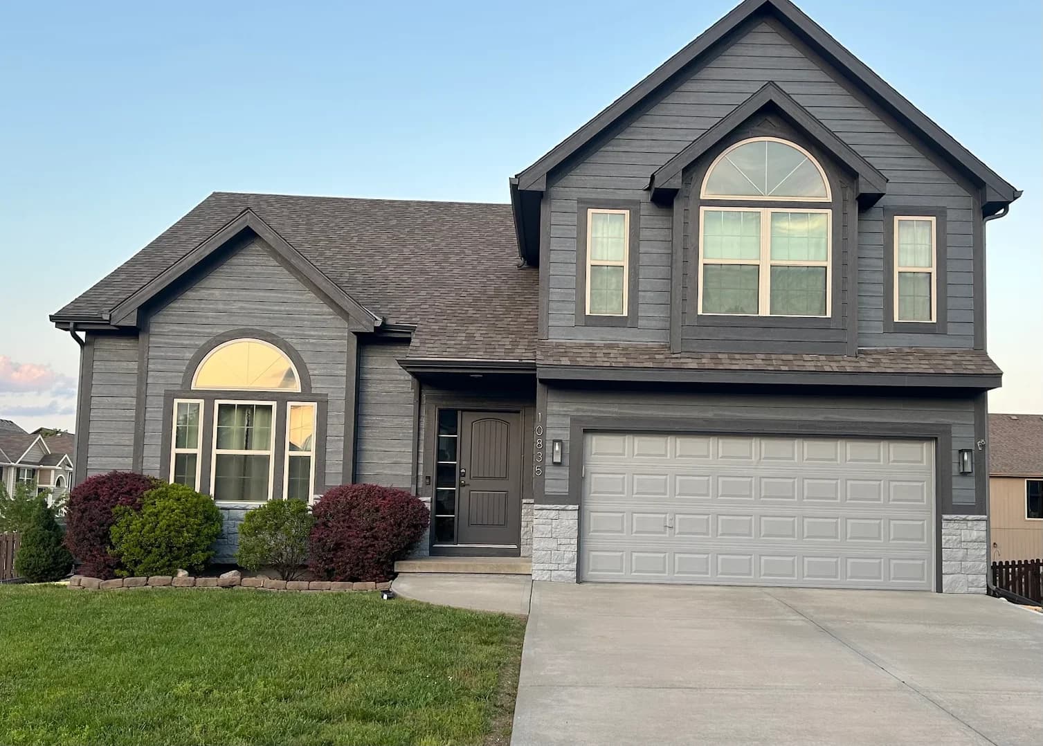 This is an image from Scarlett Painting & Remodeling. The image shows a gray-painted home exterior with coordinated trim and siding for a clean, modern finish.