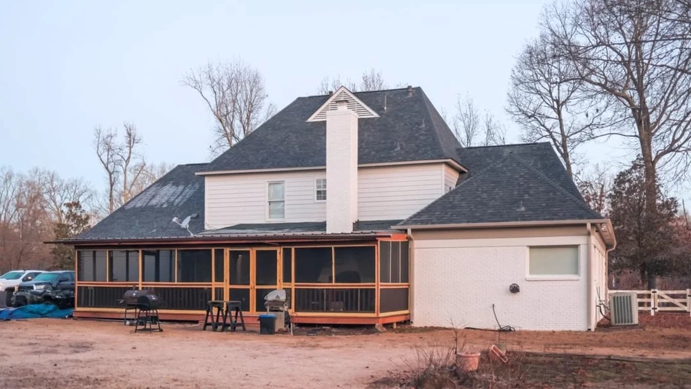 Exterior painting by Caldwell Painting Memphis in Cordova, Tennessee. The image shows a light-sided two-story home with a screened porch and dark roof.