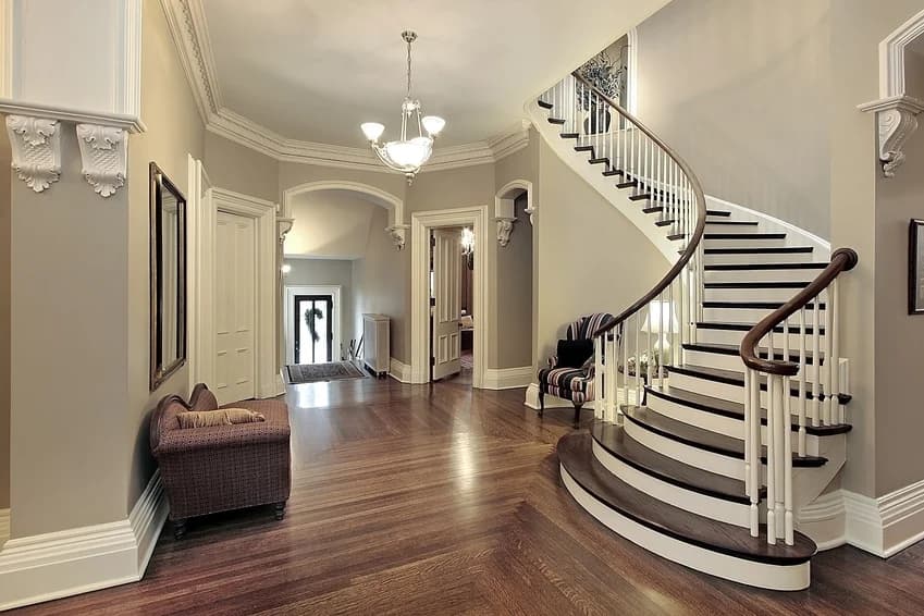 This is an image from Neighborhood Painting and Restoration. The image is interior foyer in Kansas City KS with curved staircase and freshly painted walls