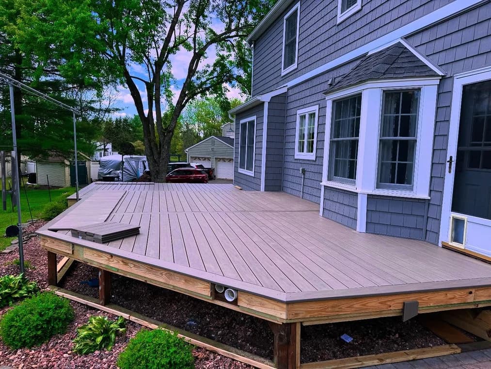 A freshly painted gray deck attached to a residential home, highlighting clean craftsmanship by Bucci Paint.