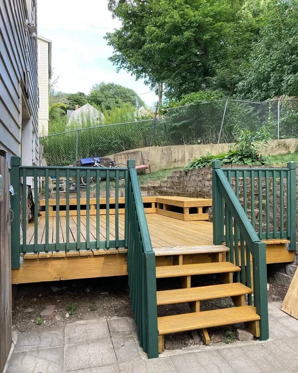 Painting work by Suzuki Painting in Whitesburg, Tennessee. The image shows a green stained deck with wood railings.