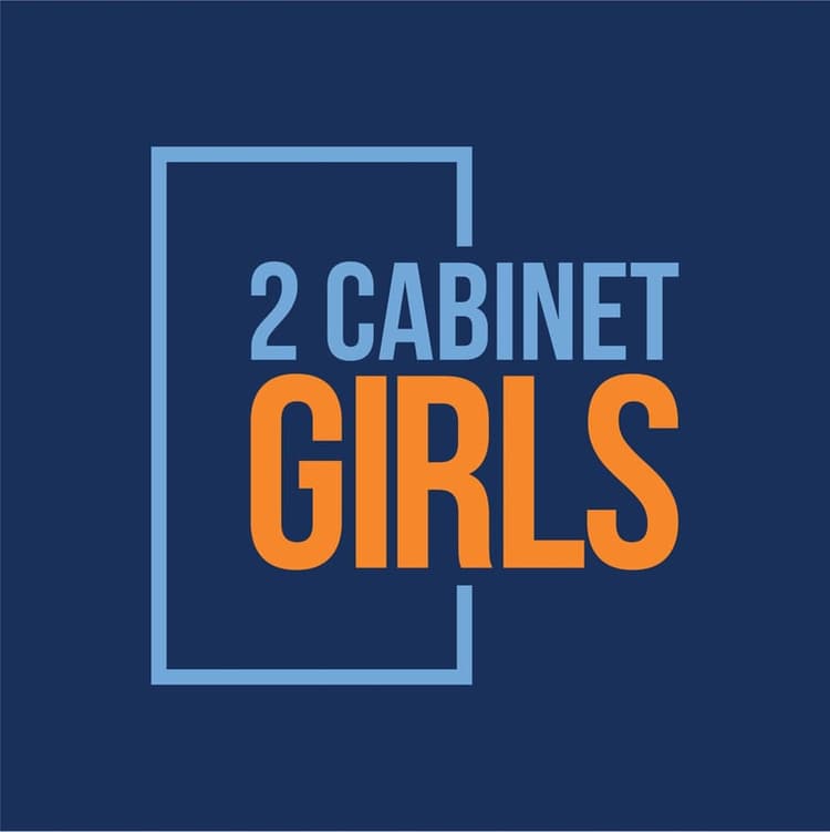 This is an image from 2 Cabinet Girls, located in North Carolina. The logo for 2 Cabinet Girls features bold orange and light blue text on a dark blue background, framed by a minimalist rectangular outline.