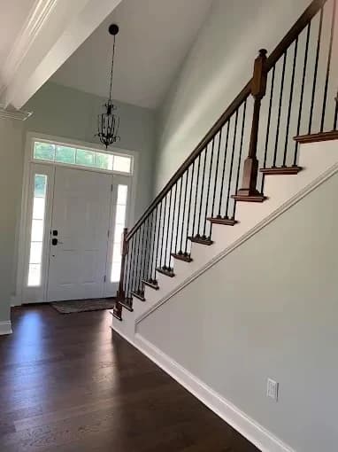 Painting work by Pilgrim Painting in Knoxville, Tennessee. The image shows a white stair foyer with dark handrails.