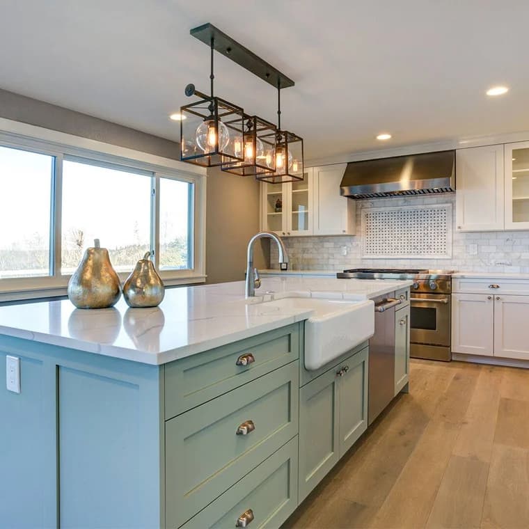 Painting work by Oak City Coatings in Raleigh, North Carolina. The image shows a kitchen with a green island and white cabinets.