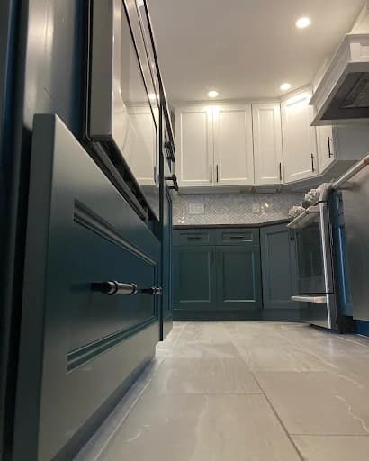 Painting work by Suzuki Painting in Whitesburg, Tennessee. The image shows a kitchen with gray cabinetry and dark counters.