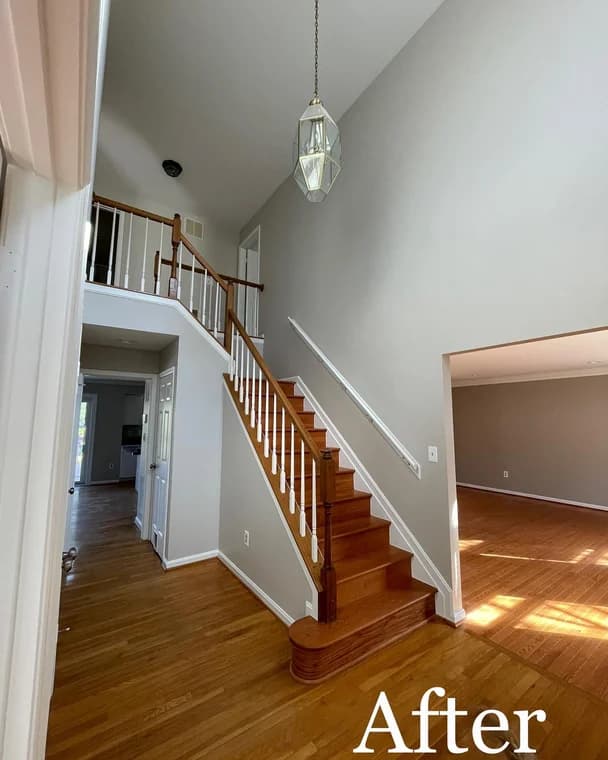 This is an image from Paint Perfection, located in Maryland. The interior hallway and staircase appear newly painted in soft gray tones with natural wood floors and white trim.