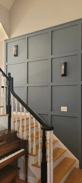 Interior painting by Artisons Painting in Brookfield, IL. The image shows a gray paneled stair wall with white trim.