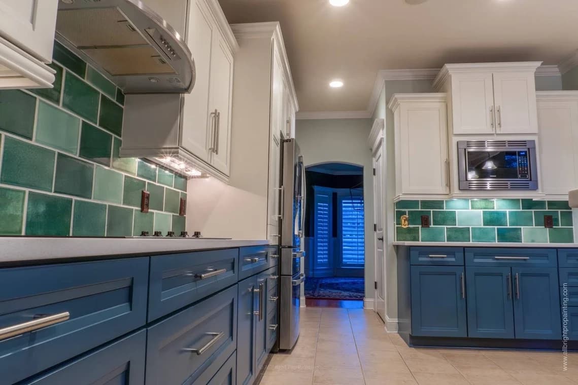 Cabinet painting by AllBright Pro Painting in Smyrna, Tennessee. The image shows blue lower cabinets, white uppers, and green tile.