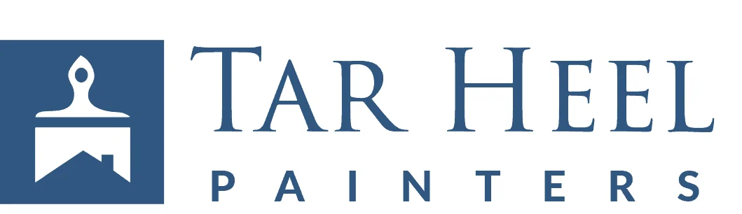 This is an image from Tar Heel Painters, located in North Carolina. This is a logo for Tar Heel Painters, featuring a paintbrush icon above a house symbol with the company name in blue text.