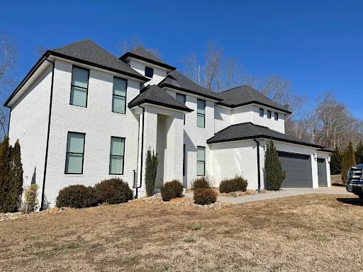 Painting work by Mike’s Painting in Oak Ridge, Tennessee. The image shows a white-and-black home exterior with crisp trim.