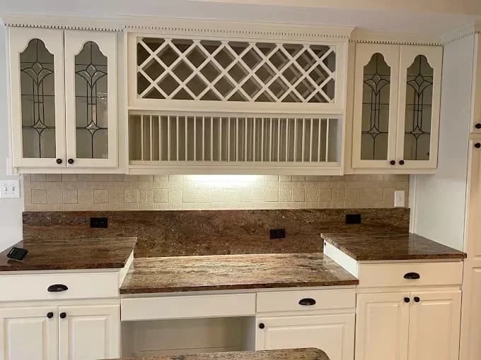 Painting work by Pilgrim Painting in Knoxville, Tennessee. The image shows white wine and bar cabinets with glass doors.