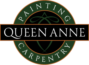 This is an image from Queen Anne Painting & Carpentry, located in Washington. The logo for Queen Anne Painting & Carpentry features a black and green circular design with white Queen Anne text and painting and carpentry lettering around the border.